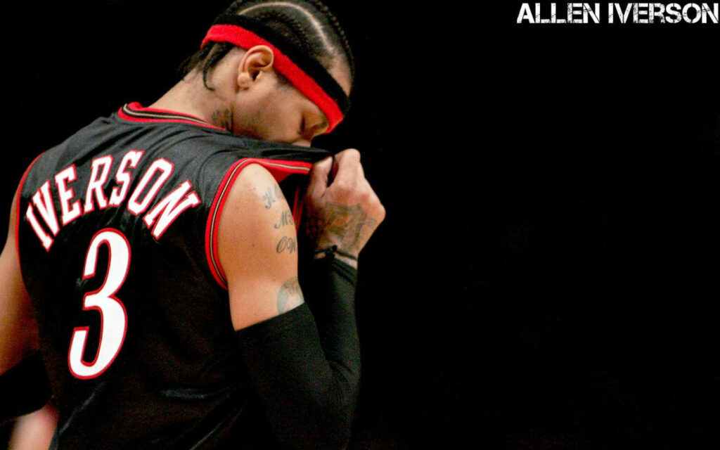 Allen Iverson wiping face with jersey basketball wallpaper showing his intensity and focus