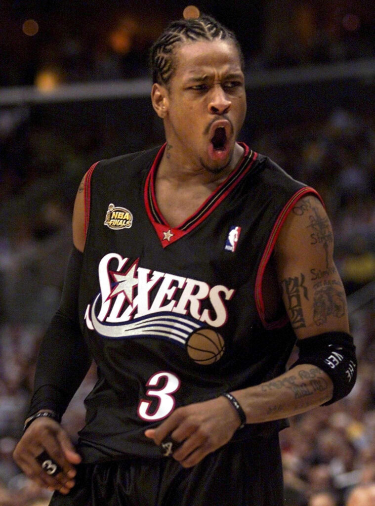 Allen Iverson shouting fiercely in Philadelphia 76ers jersey intense basketball game wallpaper background