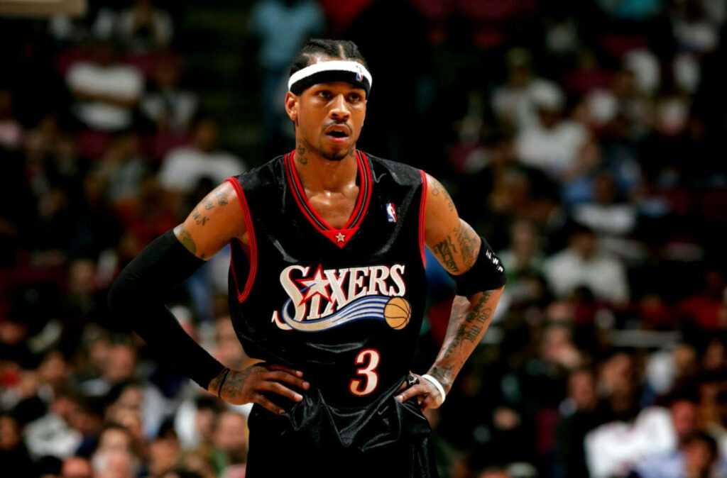 Allen Iverson on basketball court wearing Philadelphia 76ers jersey hands on waist during game Wallpaper