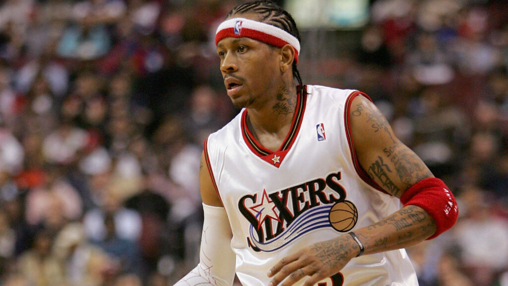 Allen Iverson dribbling basketball in Philadelphia 76ers uniform with focused game expression Wallpaper