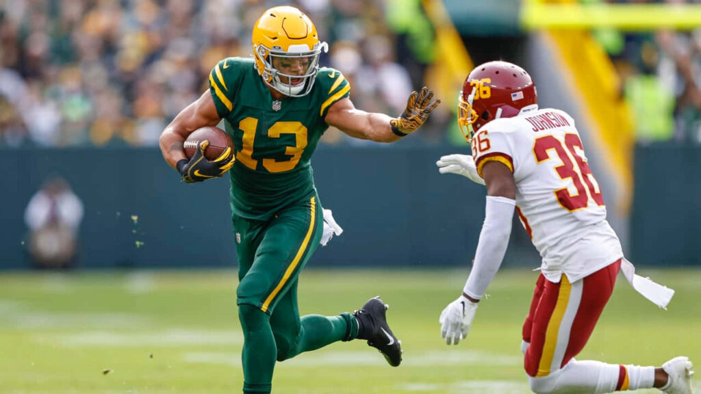 Allen Lazard runs with football evading defender in intense NFL game action wallpaper background