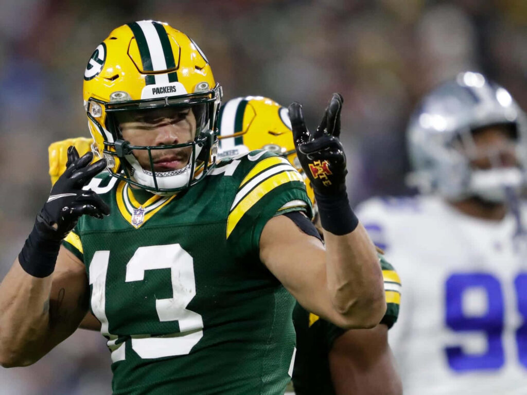 Allen Lazard Green Bay Packers celebrating on field dynamic moment in green and gold uniform Wallpaper