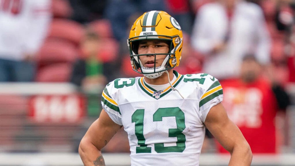 Allen Lazard Green Bay Packers uniform focused on field ready for game day action wallpaper
