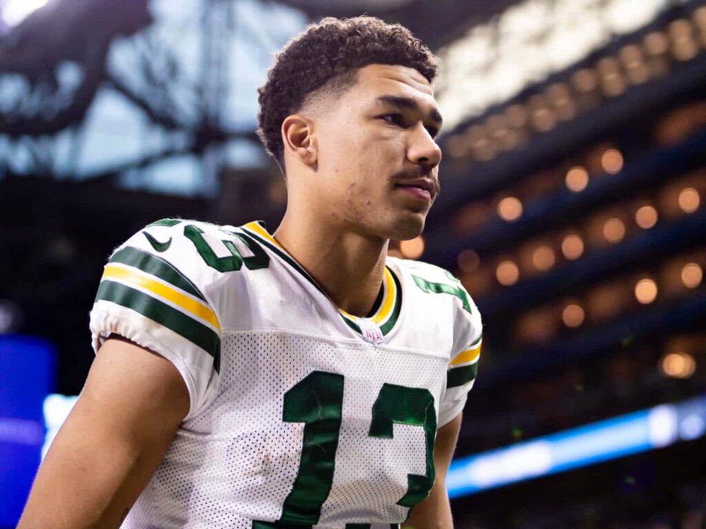 Allen Lazard Green Bay Packers number 13 focused on field with stadium background wallpaper