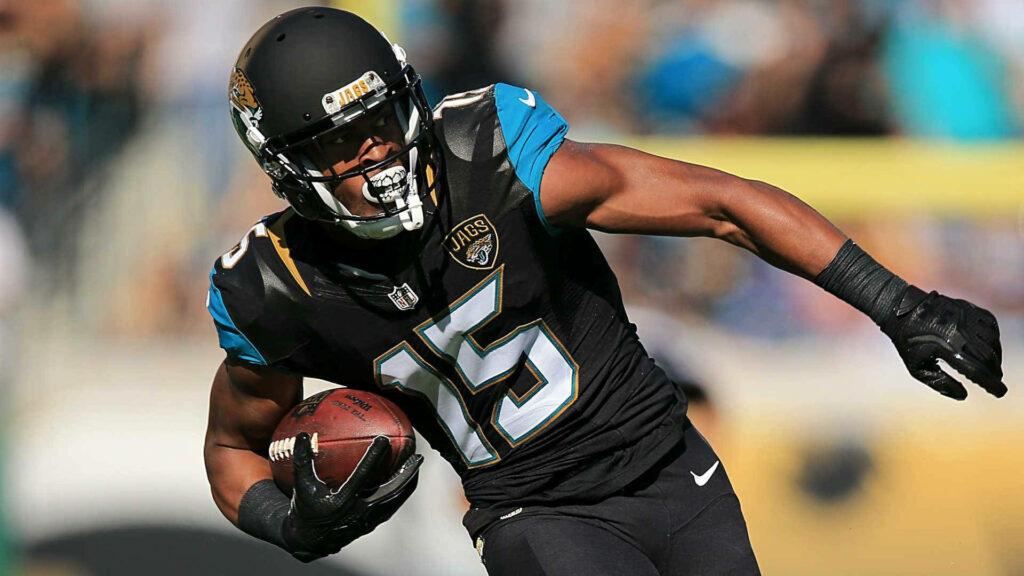Allen Robinson Jacksonville Jaguars NFL wide receiver charging forward with football intense game Wallpaper