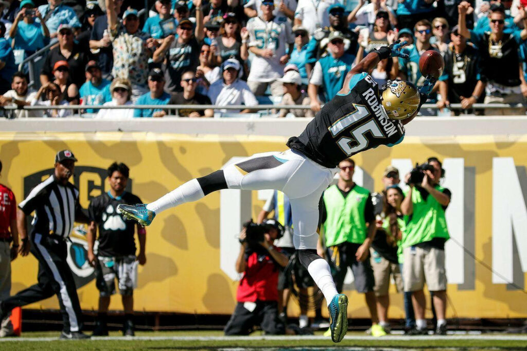 Allen Robinson airborne making a spectacular catch dynamic American football game day wallpaper