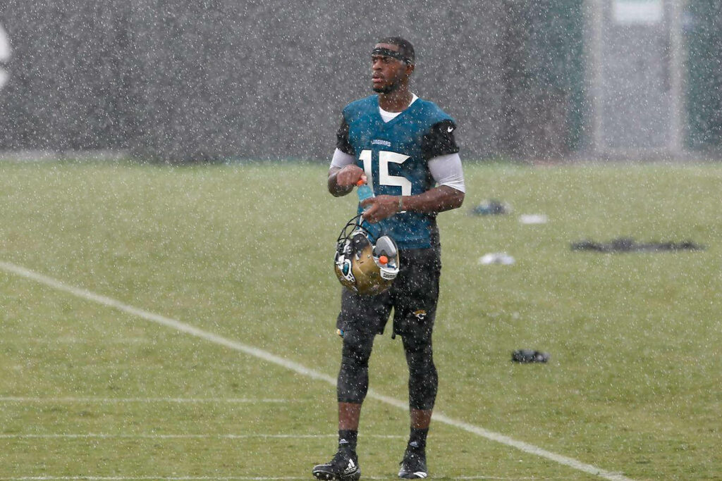 Allen Robinson in No 15 jersey focused during rainy NFL practice on wet football field wallpaper