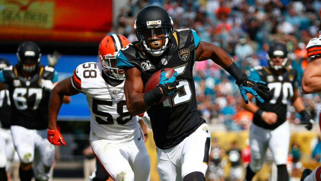 Allen Robinson running with football in NFL game against Cleveland Browns on field wallpaper