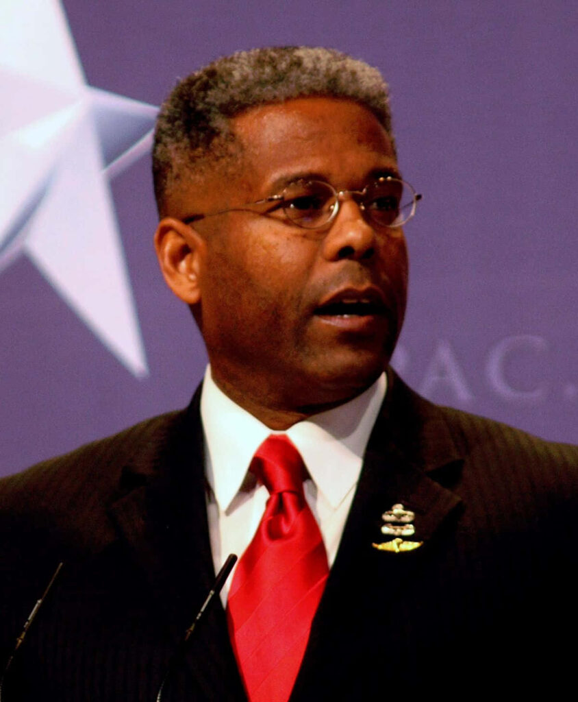 US House Representative Allen West speaking at event patriotic backdrop wallpaper background