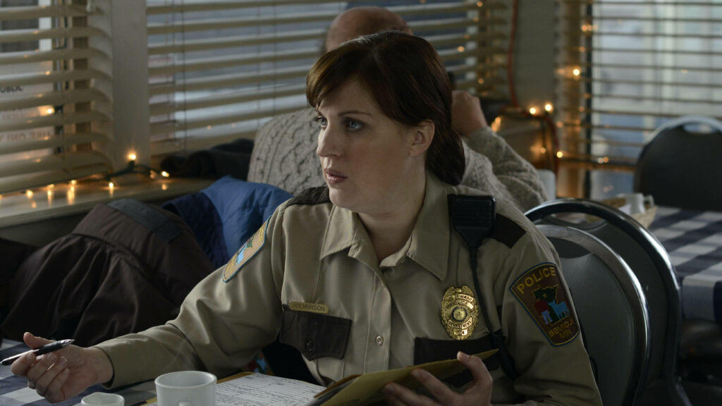 Allison Tolman as Molly Solverson in police uniform sitting focused in diner scene Fargo wallpaper