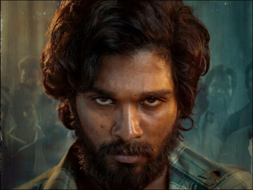Close-up wallpaper of Allu Arjun with long hair and fierce expression for intense powerful look