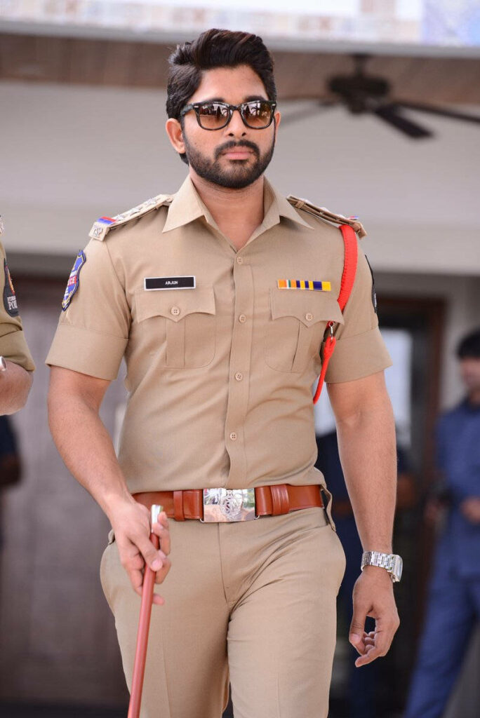 Allu Arjun in police uniform holding cane with confident authoritative look wallpaper background