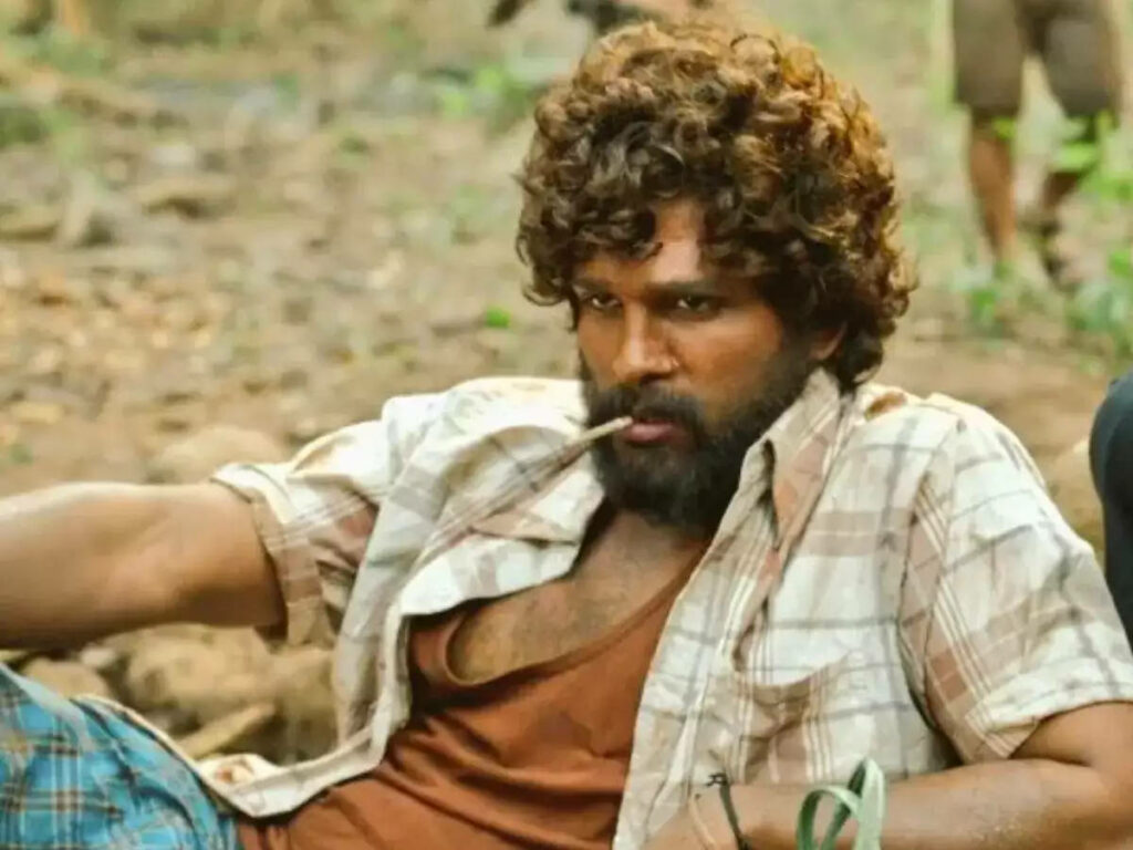 Allu Arjun as Pushpa lying on field rugged look checked shirt intense raw Pushpa movie wallpaper
