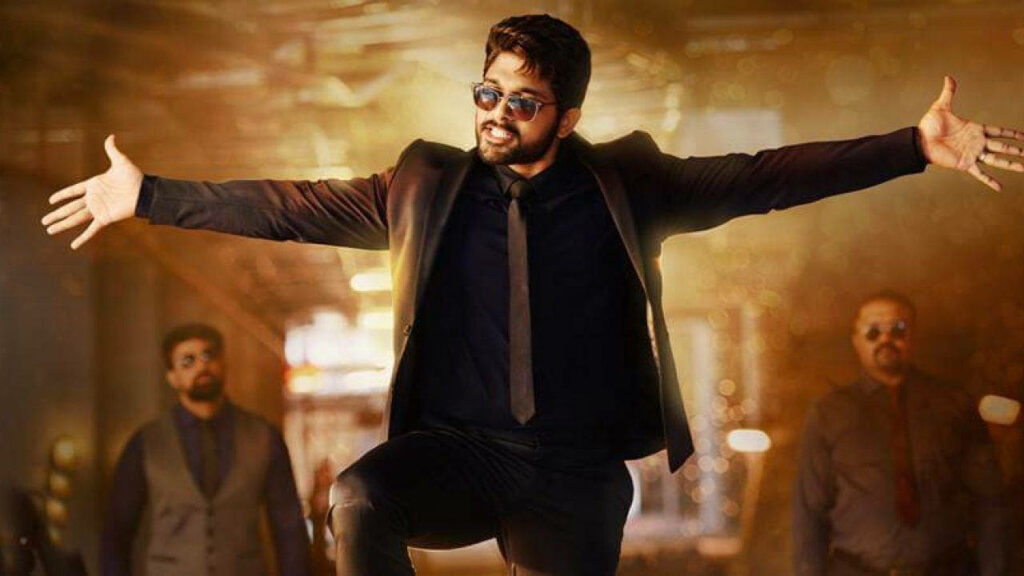 Allu Arjun in stylish suit with open arms exuding confidence and charisma dynamic wallpaper