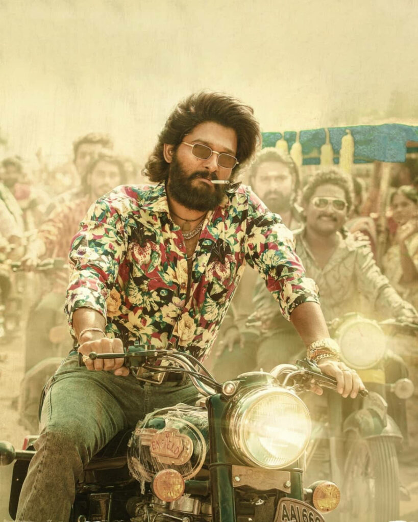 Allu Arjun on vintage motorcycle wearing floral shirt sunglasses vibrant colorful wallpaper background