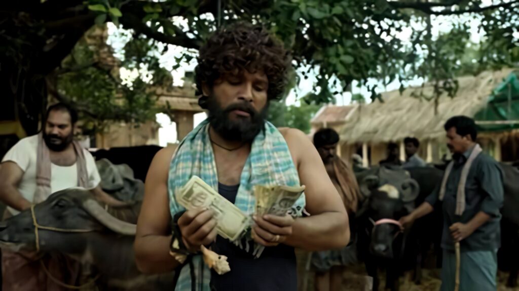 Allu Arjun as Pushpa counting money in rural farm setting with buffaloes Pushpa movie scene wallpaper