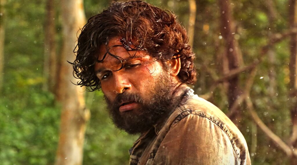 Allu Arjun as Pushpa looking exhausted and frustrated in a dense forest intense scene wallpaper