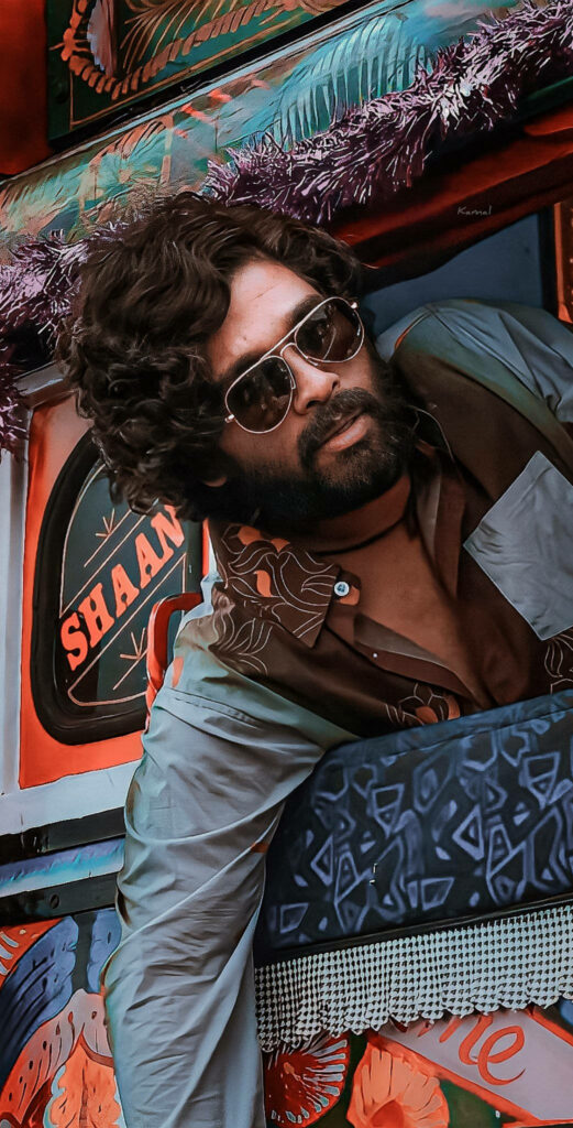 Allu Arjun as Pushpa Raj leaning out of vibrant vehicle with sunglasses stylish film wallpaper