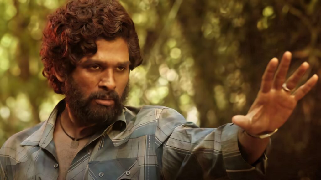 Allu Arjun as Pushpa confidently raising hand in forest intense expression rugged look wallpaper