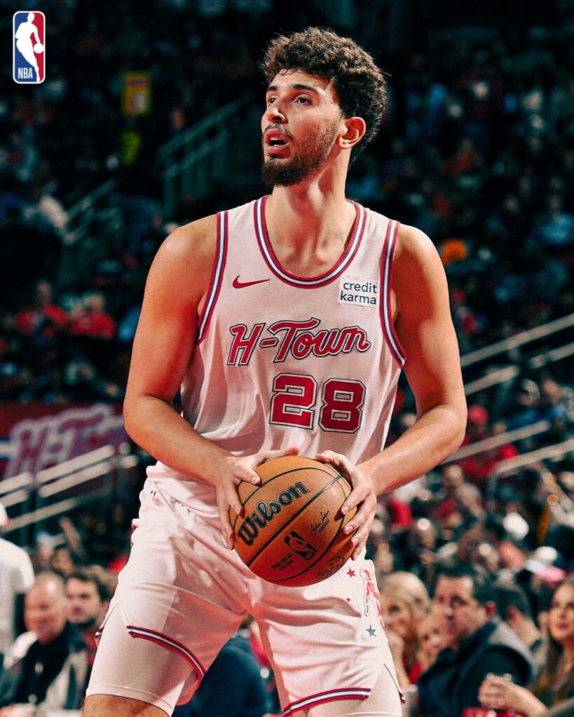 Alperen Şengün focused shooting basketball in H Town uniform dynamic sports wallpaper background