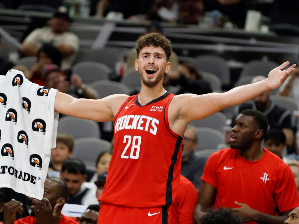 Alperen Şengün celebrating on court in Houston Rockets jersey vibrant basketball wallpaper background