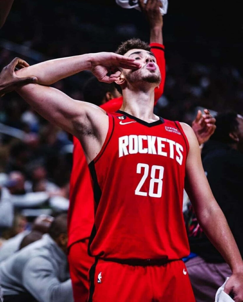Alperen Şengün celebrates on court wearing Houston Rockets jersey during intense game moment wallpaper
