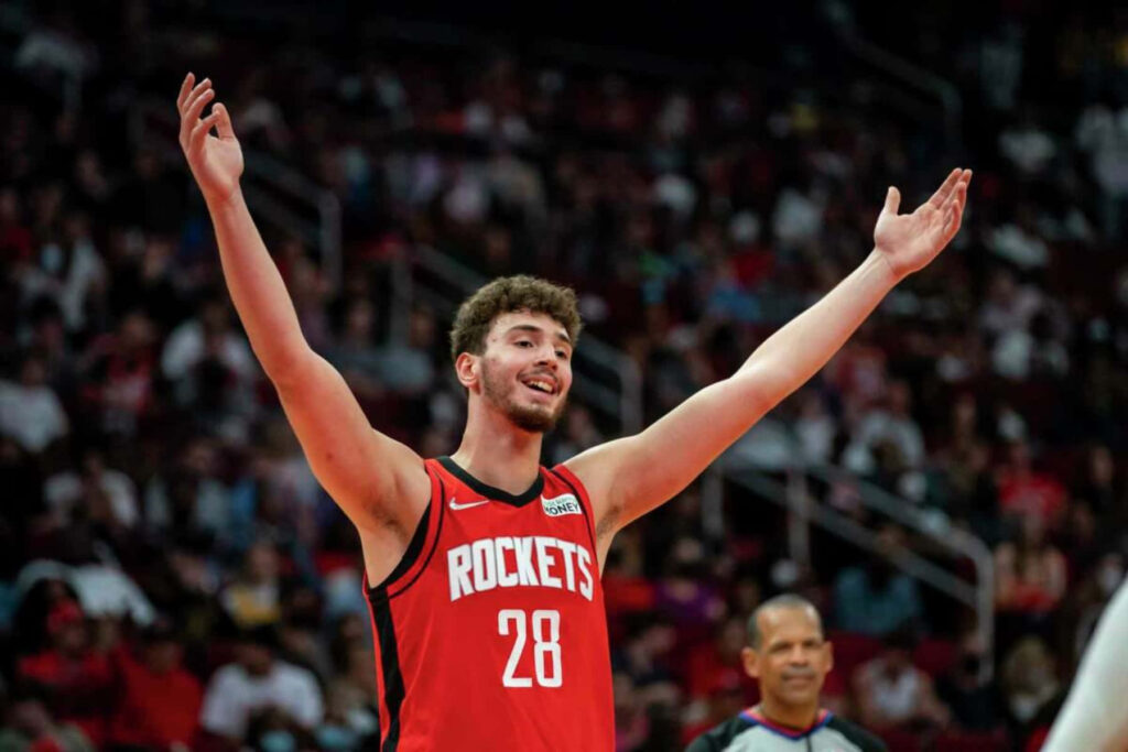 Alperen Şengün Houston Rockets celebrates on court arms raised smiling NBA game wallpaper background