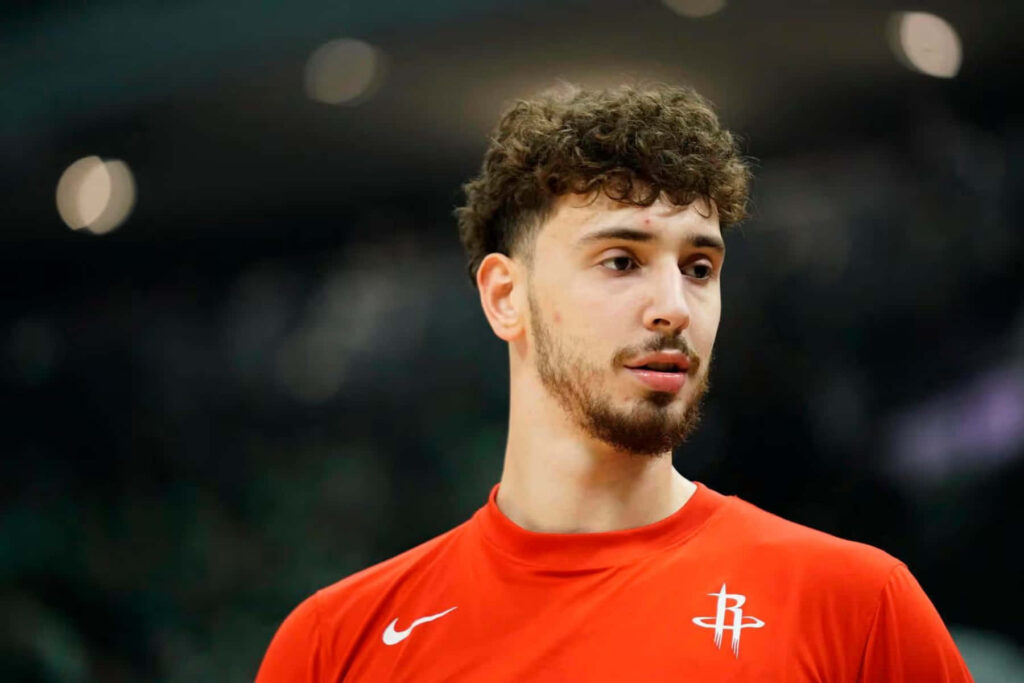 Alperen Şengün in red Houston Rockets jersey focused on basketball court dynamic wallpaper