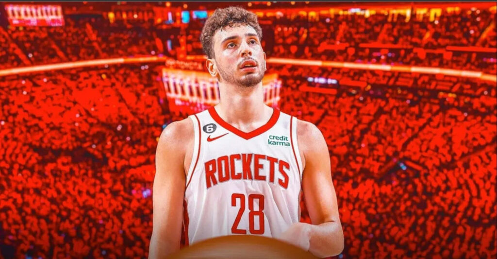 Alperen Şengün Houston Rockets uniform on court with vibrant red crowd game night energy wallpaper
