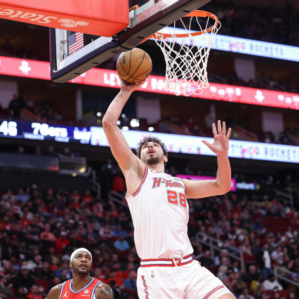 Alperen Şengün jumps for a powerful dunk showing athleticism in exciting basketball game wallpaper