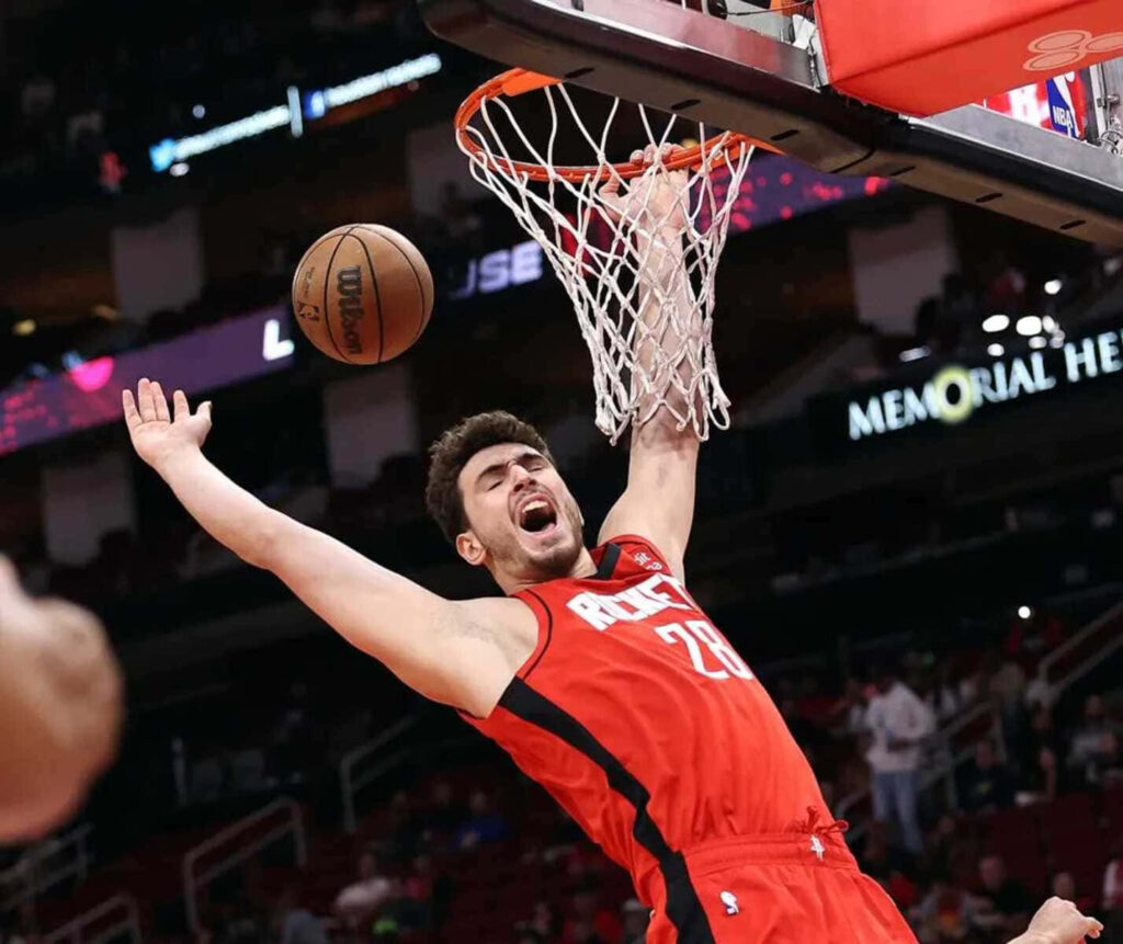 Alperen Şengün mid-air powerful dunk basketball game electrifying court action wallpaper background