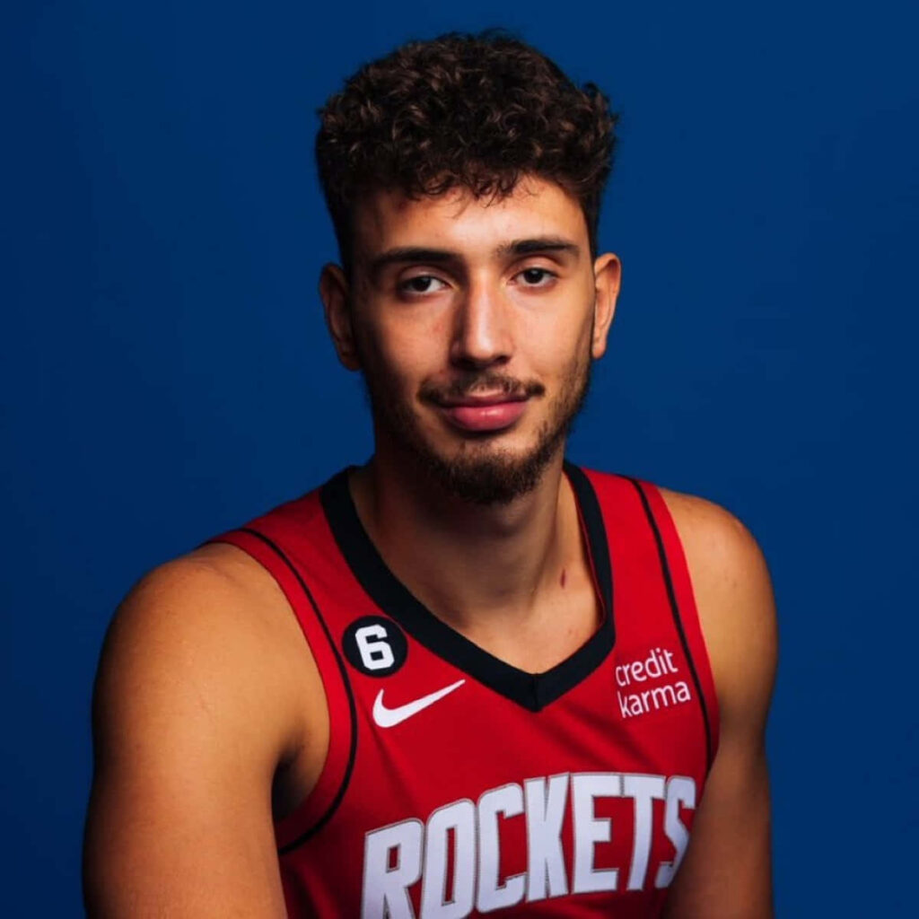 Alperen Şengün in red Rockets jersey on blue background vibrant basketball fan wallpaper