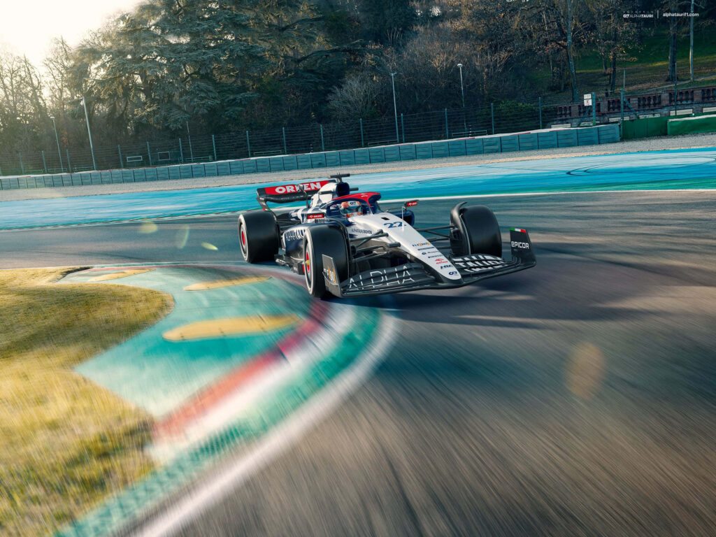 AlphaTauri high-performance automatic race car speeding on vibrant racetrack showcasing engineering Wallpaper