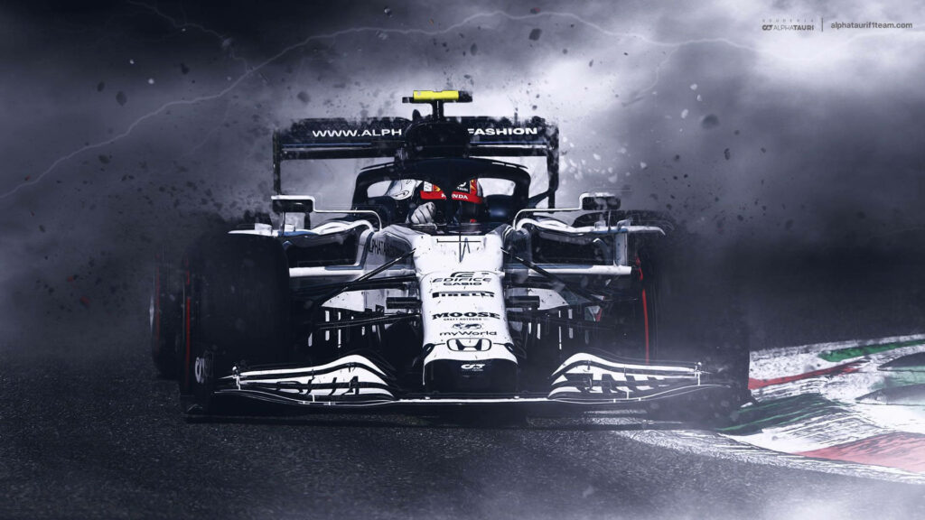 AlphaTauri Formula 1 car racing through stormy track with dynamic motion and sharp focus wallpaper