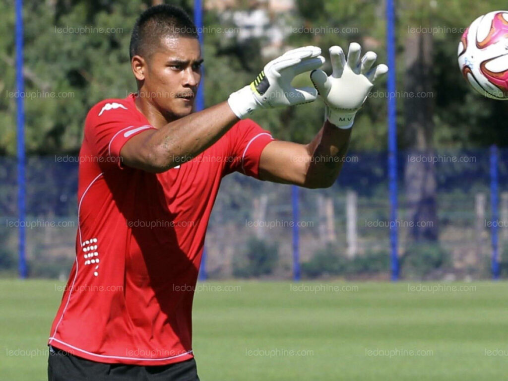Alphonse Areola focused catching soccer ball with gloves during training session on field wallpaper