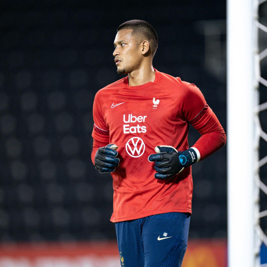 Alphonse Areola jogging on French national team training field focused during practice session Wallpaper