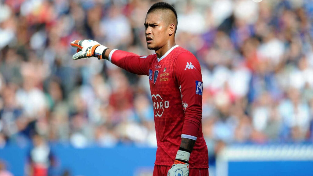 Alphonse Areola goalkeeper in uniform directing defense during soccer match action wallpaper background