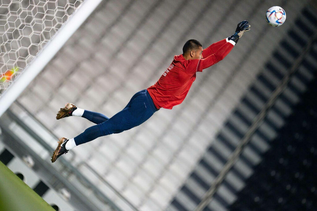 Alphonse Areola mid-air dive saving goal fully focused football match action wallpaper background