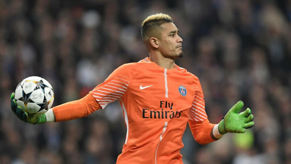 Goalkeeper Alphonse Areola in orange PSG kit holding ball preparing to throw during match wallpaper