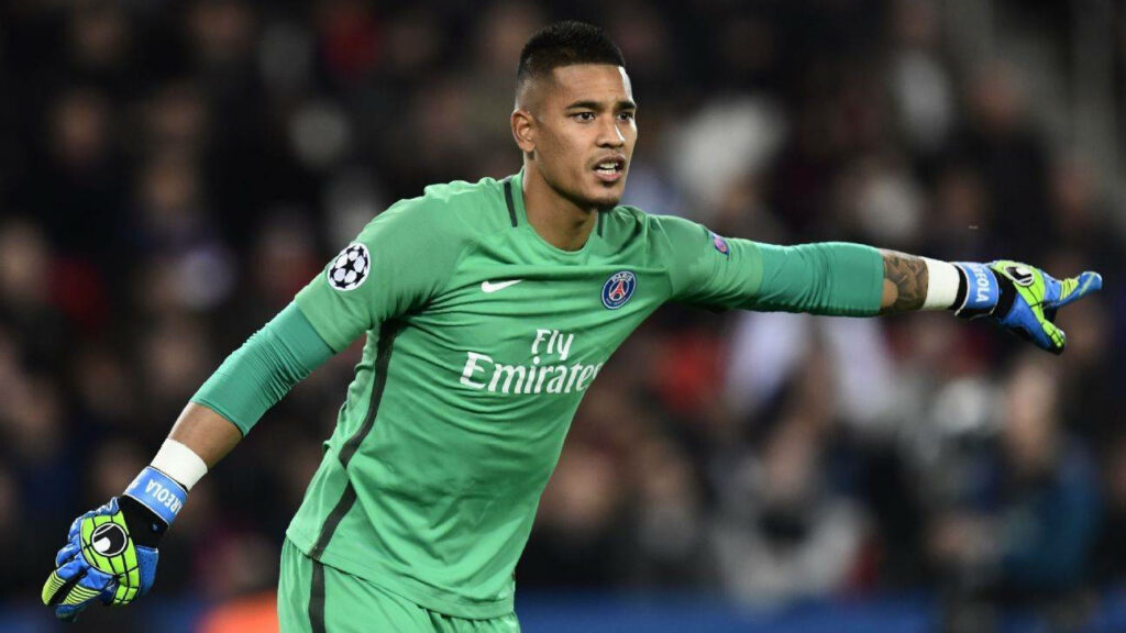 Alphonse Areola in PSG goalkeeper kit directing defense during UEFA Champions League match wallpaper