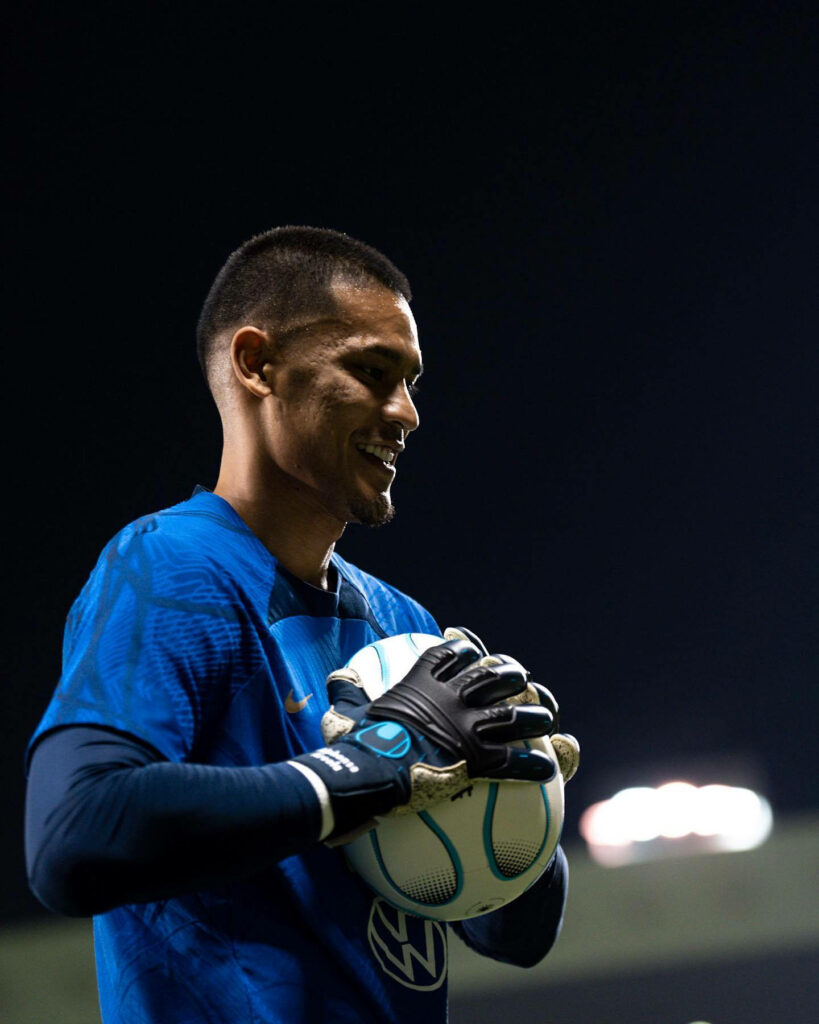Alphonse Areola smiling holding football during night training session in illuminated stadium Wallpaper