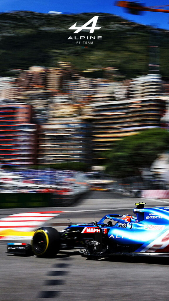 Alpine Formula 1 car racing fast on city circuit with dynamic motion blur wallpaper background