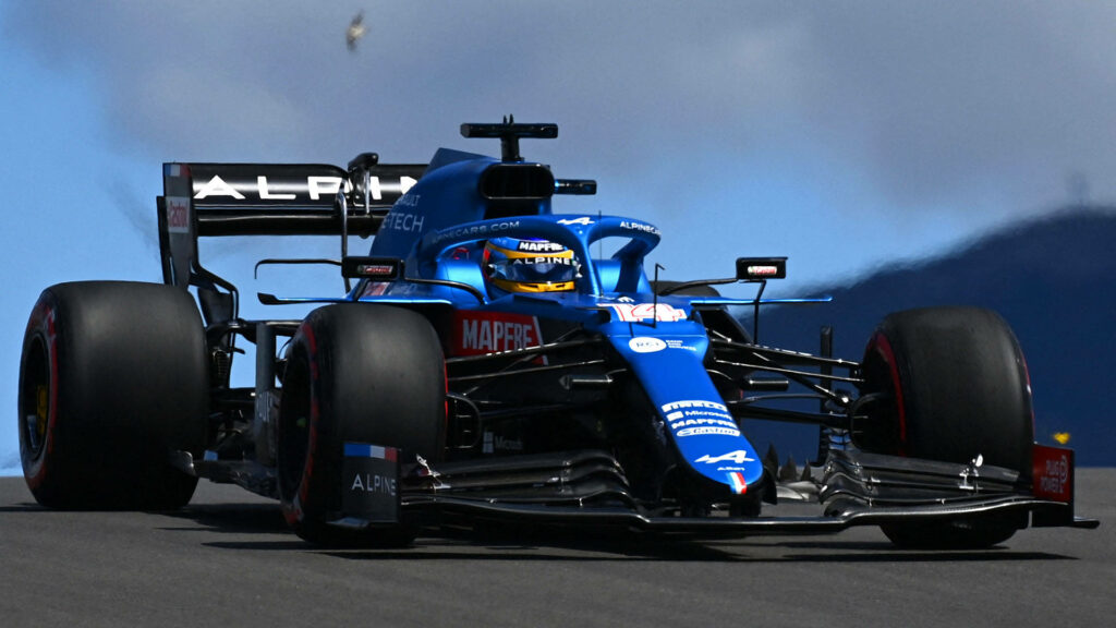 Close-up of Alpine Formula 1 car speeding on track with bold blue aerodynamic design wallpaper