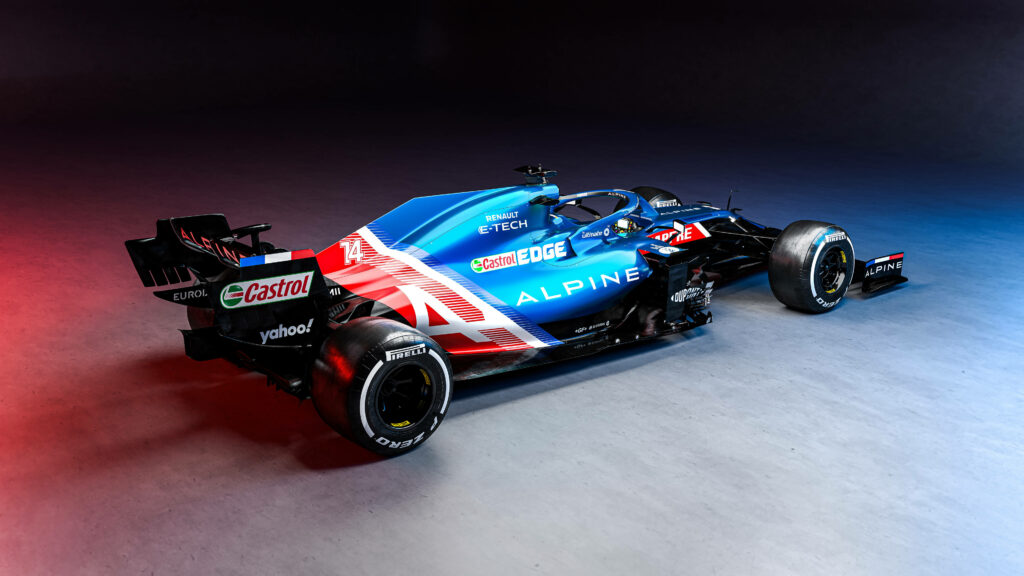 Side view of Alpine Formula 1 car with blue red livery and sleek aerodynamic design wallpaper