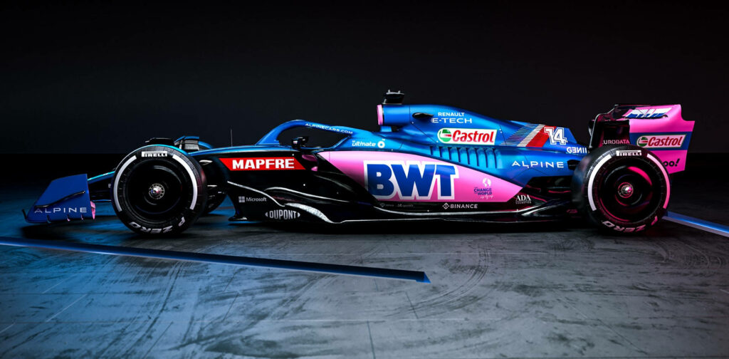 Alpine race car with bold blue and pink livery showcased in dark room highlighting aerodynamic design Wallpaper