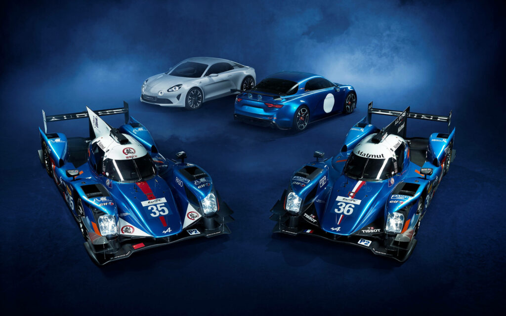 Alpine race cars and sporty road cars lineup with dramatic blue alpine backdrop wallpaper