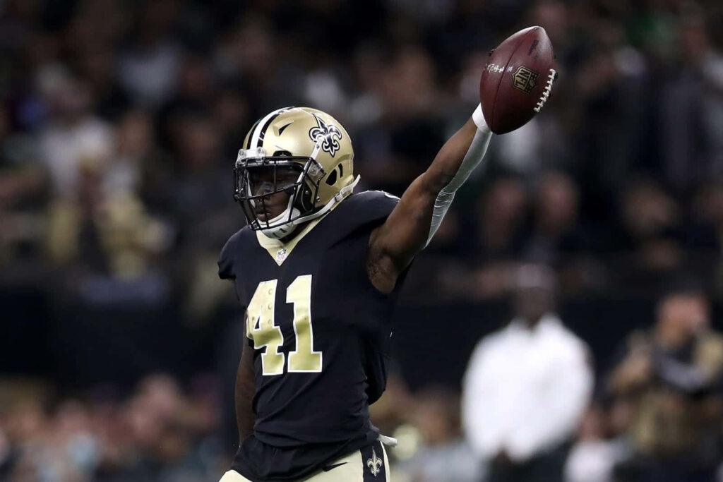 Alvin Kamara celebrates touchdown in New Orleans Saints uniform with stadium crowd behind Wallpaper