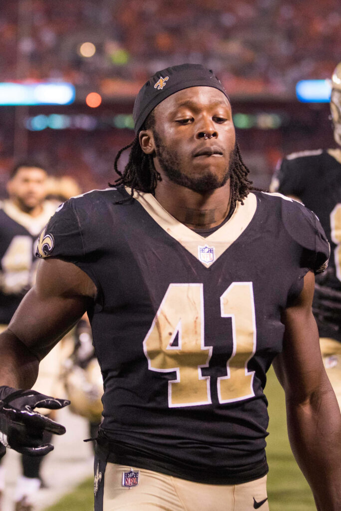 Alvin Kamara New Orleans Saints running back focused on football field striking wallpaper background