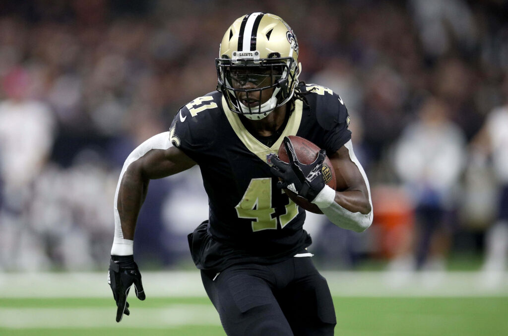 Alvin Kamara New Orleans Saints running with football charging for touchdown action wallpaper