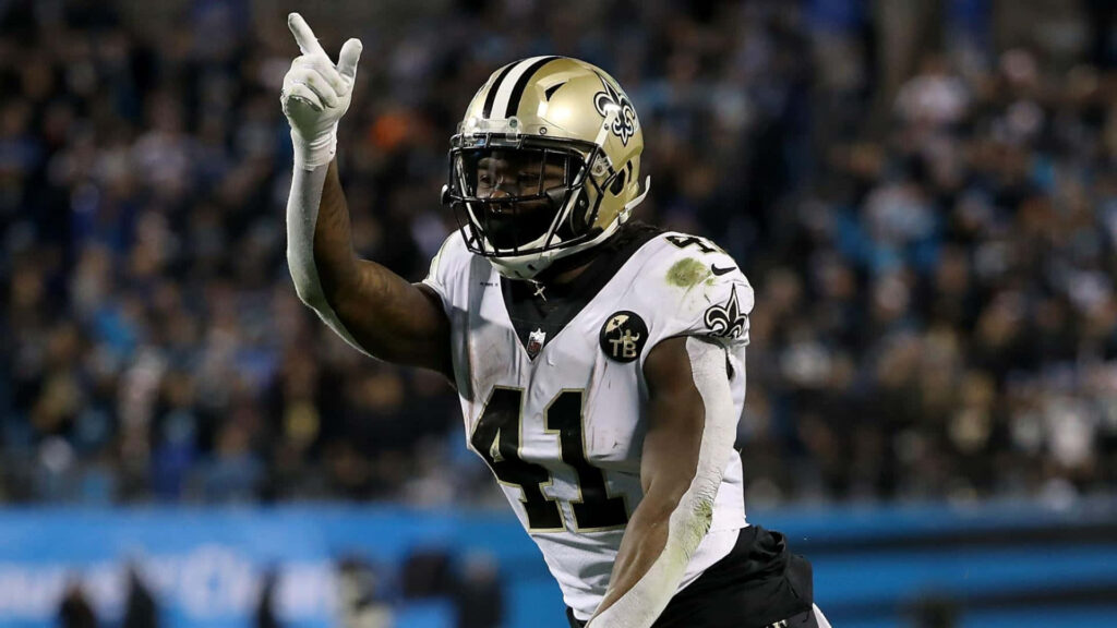 Alvin Kamara New Orleans Saints football action intense game moment wallpaper background